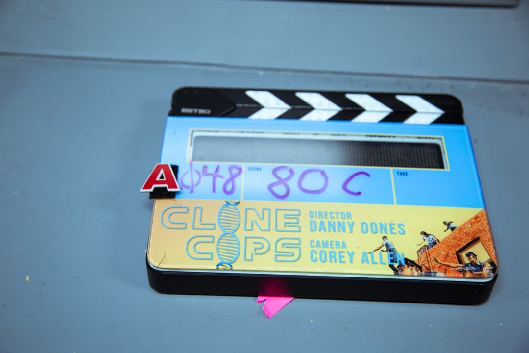 Behind the scenes photo 54 from Clone Cops production showing custom slate used for clone cops